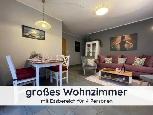 a living room with a couch and a table at Der Fuchsbau - Fewo LePetit - im sonnigen Harz - Hunde willkommen - 100m bis zum Wald - FREE WLAN in Bad Sachsa