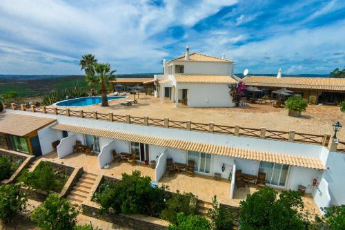 an aerial view of a villa with a swimming pool at Monte da Bravura Green Resort in Bensafrim