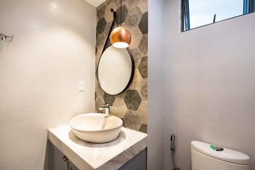 a bathroom with a sink and a mirror on a counter at Everrich Q5 - Two Bedroom in Ho Chi Minh City