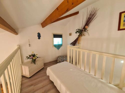 a white room with a crib and a window at Maison Saint-Jean-de-Monts, 3 pièces, 5 personnes - FR-1-224C-125 in Saint-Jean-de-Monts