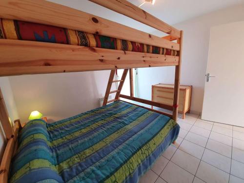 une chambre avec un lit superposé dans une pièce dans l'établissement Appartement 3 pièces avec balcon, piscine collective et parking proche océan à Saint-Hilaire-de-Riez - FR-1-224C-250, à Saint-Hilaire-de-Riez