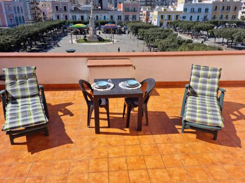 a table and two chairs on a patio with a view at La terrazza di nonno Ciccio in Monopoli
