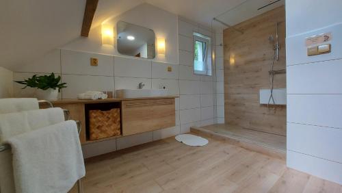 a large bathroom with a sink and a shower at Apartmány Pod Lesem in Rodvínov