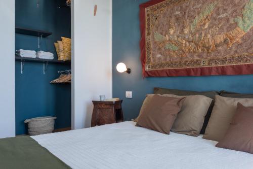 a bedroom with a bed and a tapestry on the wall at Casa del Toro allo Stadio Filadelfia by Wonderful Italy in Turin