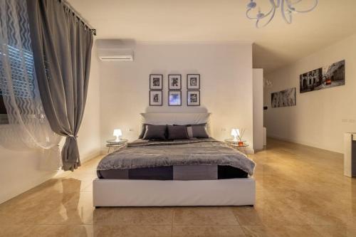 a bedroom with a large bed in a room at San Babila - Luxury Milanese Apartment in Milan