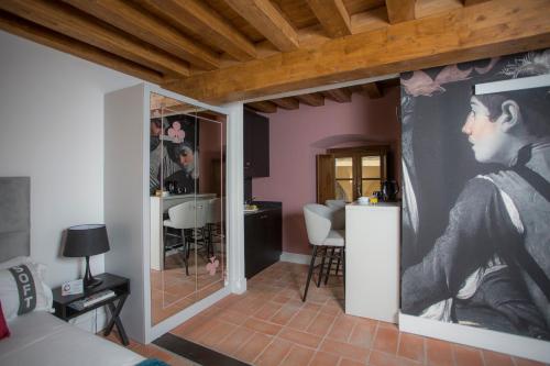 a living room with a large painting of a man on the wall at Casual Rinascimento Firenze in Florence