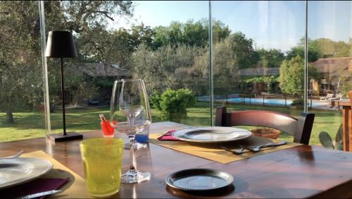 a wooden table with a glass of wine on it at Agriturismo Eco-Bio Villa Vacasio in Pitigliano