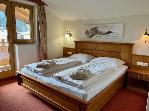 a bedroom with a bed with two pillows on it at Loipenstubn in Brixen im Thale