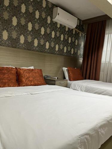 a hotel room with two beds and a window at Metro Otel in İzmir