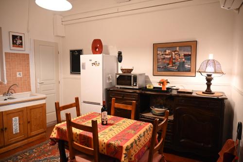 a kitchen with a table and a refrigerator at Family Apartment Old Town near Beach AC in Nice