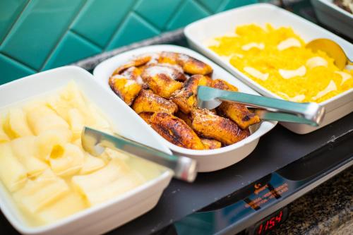 two trays of food on a counter with dip at Pousada Mariluz in Maragogi