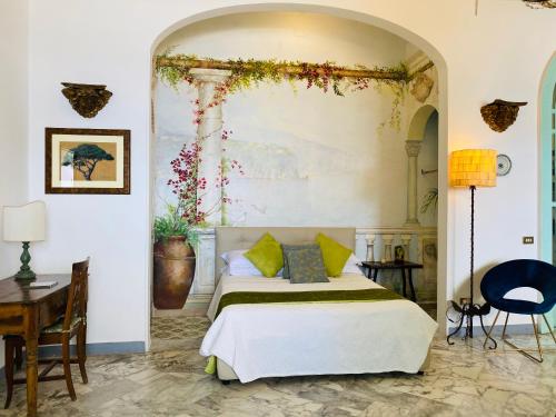 a bedroom with a bed with areath on the wall at Villa La Terrazza Suites in Sorrento