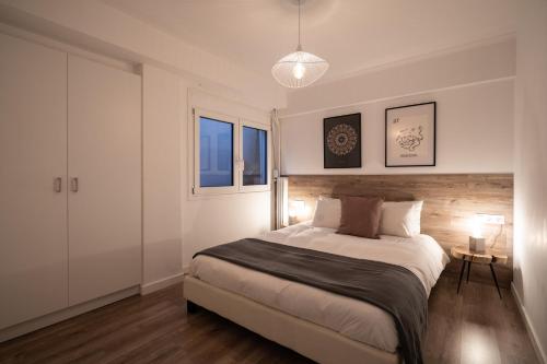 a bedroom with a large bed and two windows at Plaka With Acropolis Rooftop View Access in Athens