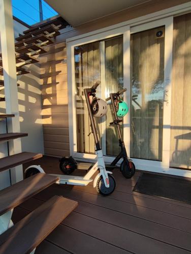 a scooter parked on the porch of a house at SEA LUX FLOATING HOUSE AJDA Portorose in Portorož