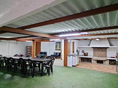 a dining room with a table and chairs and a fireplace at CASA GORIS in Villanueva de Arosa