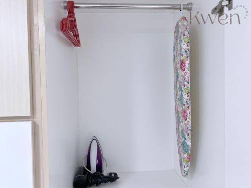 a shower curtain hanging on a wall next to a door at KWEN Suites-Tanjung Aru InfinityPool Seaview/Airport View in Kota Kinabalu