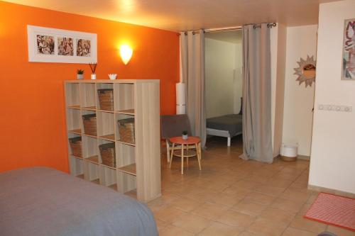 a bedroom with a bed and a room with a table at LE LIT QUI DANSE in Mollans-sur-Ouvèze