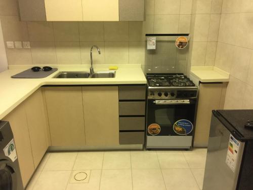 a small kitchen with a sink and a stove at Rental unit in alraha village -marsa zayed مرسى زايد- قرية الراحة in Aqaba