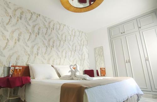 a bedroom with a bed with a stuffed animal on it at Hotel Sol Almería in Almería