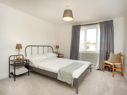 a bedroom with a bed and a window at Eugene Sands in Paignton