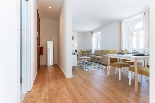 a living room with a table and a couch at Sintra Flower Lux Apartments in Sintra