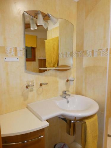 une salle de bain avec un lavabo et un miroir dans l'établissement Chambre Le mas d'Adelice, à Taulignan