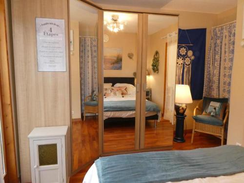 a room with a bedroom with a bed and a mirror at Chambre Le mas d'Adelice in Taulignan