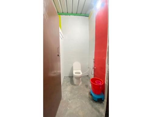 a bathroom with a toilet and a bucket at Oakland Camping, Uttarkashi in Uttarkāshi