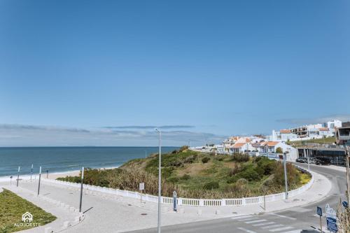 a road next to a beach with houses and the ocean at BC Beach House - Santa Cruz in Santa Cruz