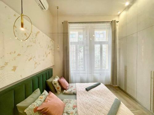 a living room with a couch and a window at Logodi Apartment #castle #freeparking in Budapest