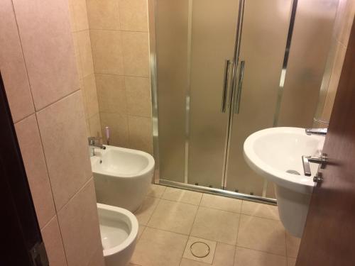 a bathroom with a shower and a sink and a toilet at Rental unit in alraha village -marsa zayed مرسى زايد- قرية الراحة in Aqaba