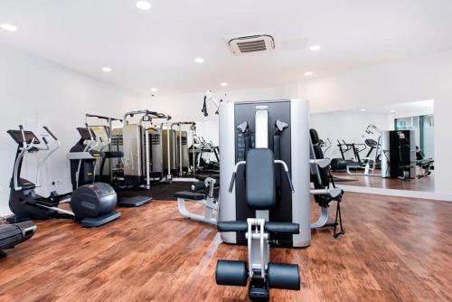 a gym with several treadmills and exercise bikes at Luxury Top Floor Apartment in London in London