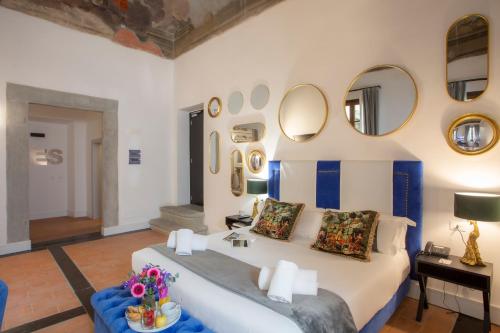 a bedroom with a bed and mirrors on the wall at Casual Rinascimento Firenze in Florence