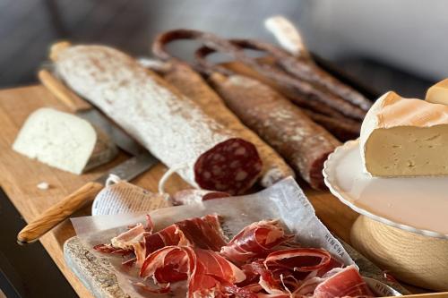 a table with bread and meats and cheese on it at Hotel MIM Andorra in Escaldes-Engordany