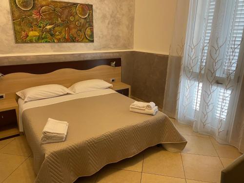 a bedroom with a bed with two towels on it at Bed and breakfast KALE ' in Porto Cesareo