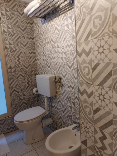 a small bathroom with a toilet and a shower at Hotel Biscari in Catania