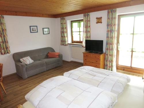 a living room with a bed and a couch at Ferienhof Landhaus Michael in Böbrach