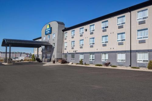 an empty parking lot in front of a hotel at Days Inn & Suites by Wyndham Yorkton in Yorkton