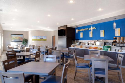 a restaurant with tables and chairs and a counter at Days Inn & Suites by Wyndham Yorkton in Yorkton
