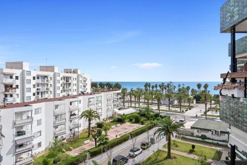 a view of a street with palm trees and buildings at Formentor 863 in Salou