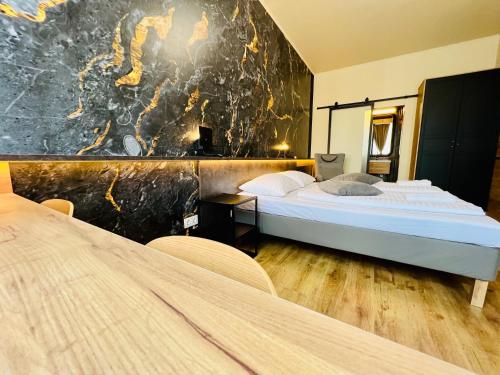 a hotel room with two beds and a wall with a mural at Boutique Hotel & Event Center in Budapest