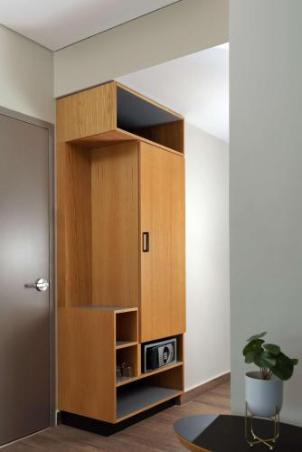 a large wooden cabinet in a room with a potted plant at Hyatt Place Monterrey Valle in Monterrey