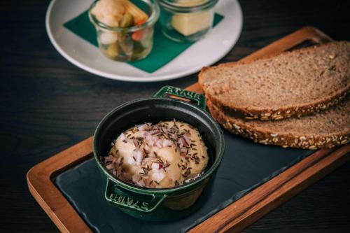 a table with a bowl of food and a plate of bread at Vienna House by Wyndham MQ Kronberg in Kronberg im Taunus