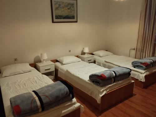 a room with three beds in a room at DCK Apartments in Kostrena