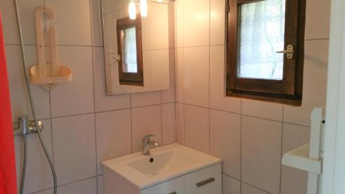 a white bathroom with a sink and a mirror at Résidence Cap Azur Appartement 108 in Villeneuve-Loubet