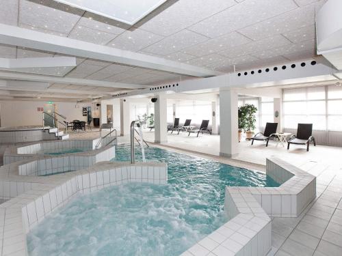 a large pool with a hot tub in a building at 6 person holiday home on a holiday park in Blokhus in Blokhus