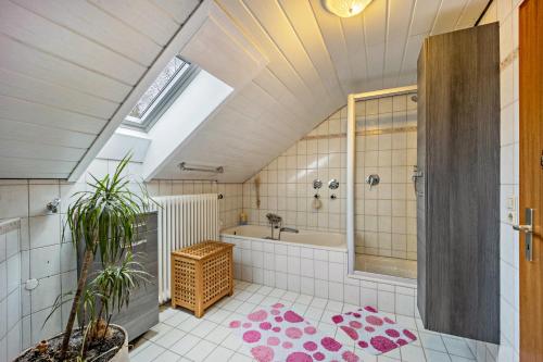 a bathroom with a shower and a tub and a sink at Elli in Aulendorf
