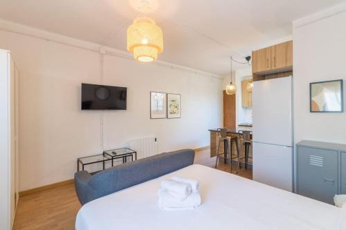 a living room with a white table and a couch at BeBarceloner Sant Andreu Apartments - Studio in Barcelona