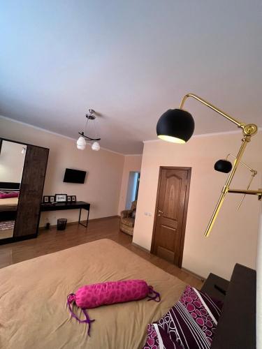 a bedroom with a bed with a pink object on the floor at Opushka in Vorobʼyëvka