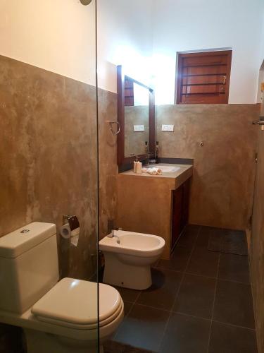 a bathroom with a toilet and a sink at Misty Hills Villa Kadugannawa in Kadugannawa